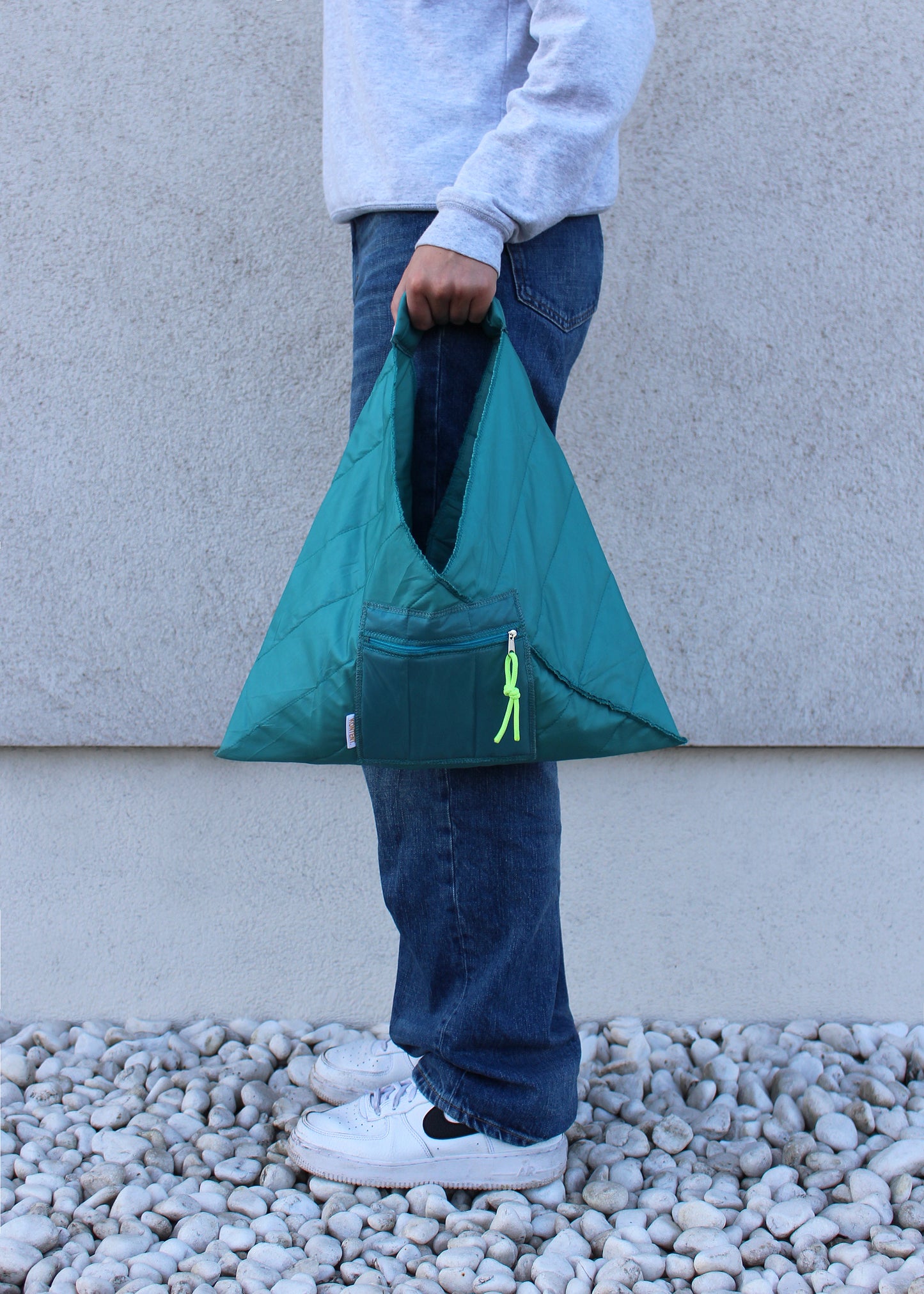 Grey mini quilted triangle bag with black trims